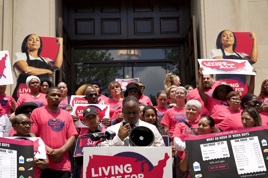 Rep. Jonathan Jackson speaks with a megaphone at the podium