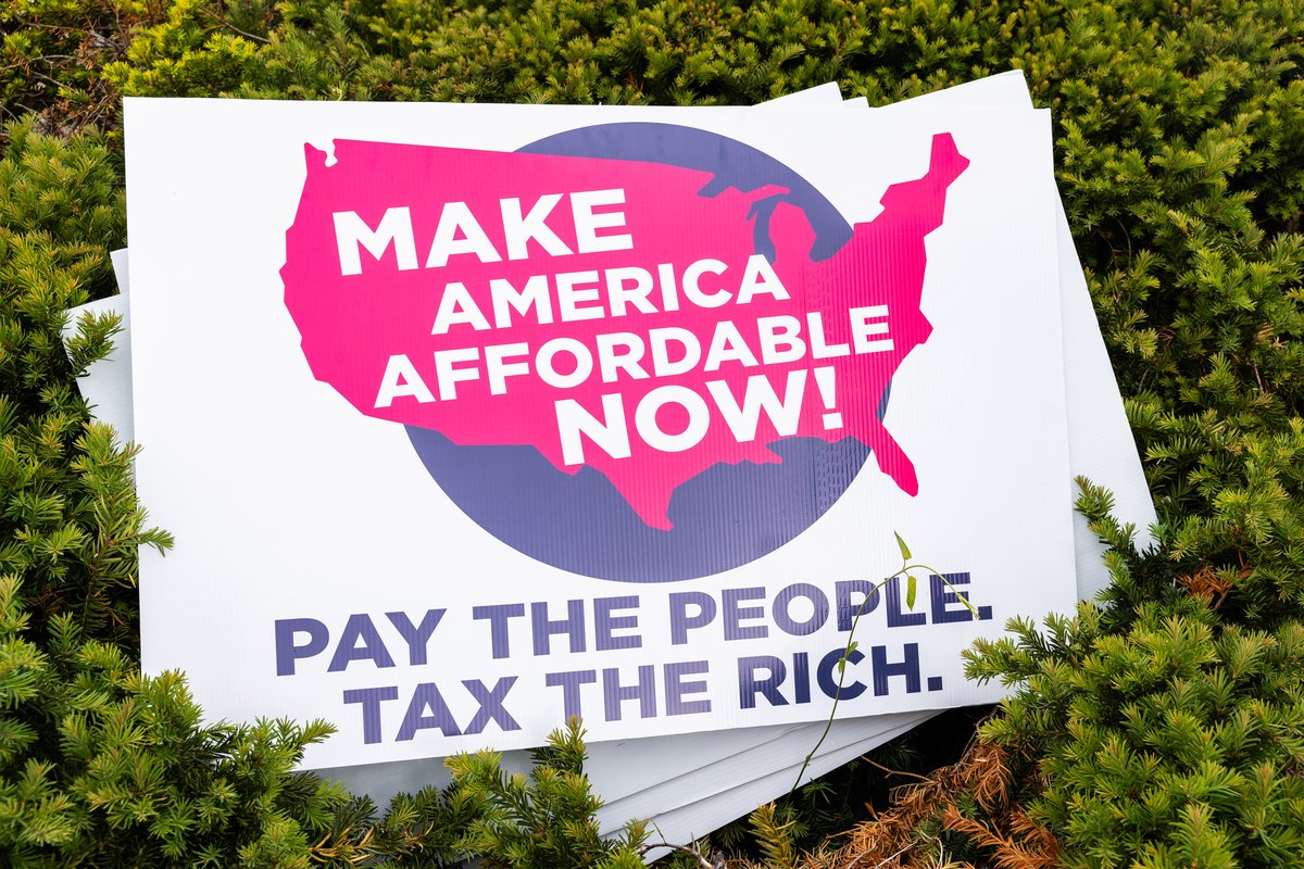 A Make America Affordable Now Pay the People Tax the Rich sign during setup for the federal Living Wage For All Act introduction